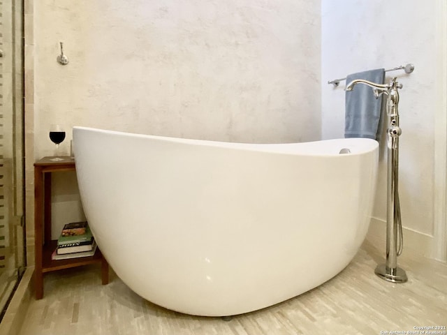 bathroom featuring a bathtub and hardwood / wood-style floors