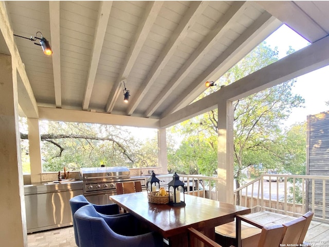 wooden deck with exterior kitchen, a grill, and sink