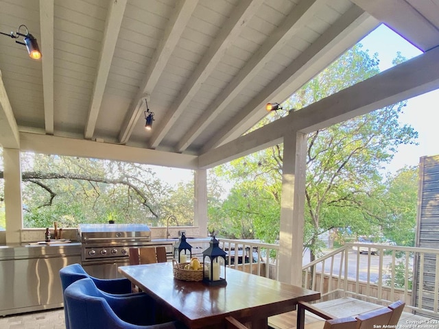 wooden deck with area for grilling, sink, and exterior kitchen