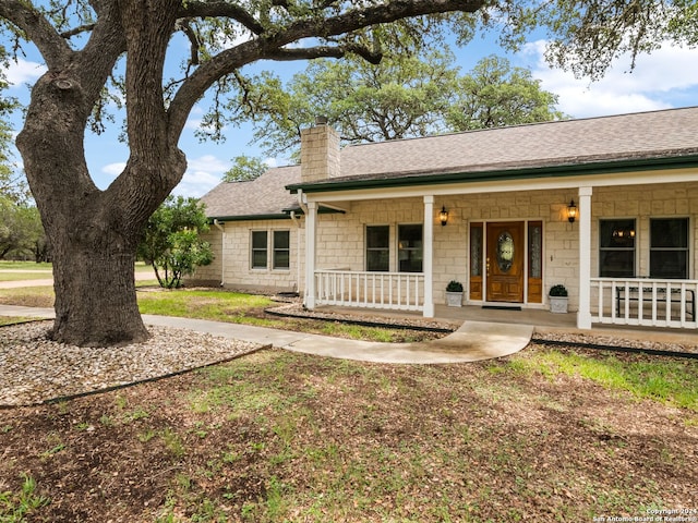 143 Cascade Caverns, Boerne, TX 78015 - ranch-style house with a porch, a chimney, and roof with shingles