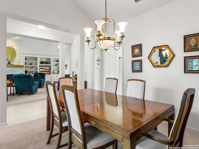 143 Cascade Caverns, Boerne, TX 78015 - dining space with vaulted ceiling, a fireplace, ornate columns, and light carpet