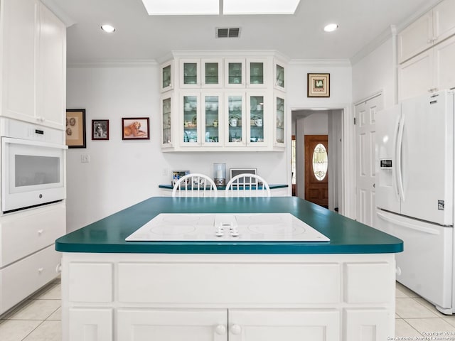 143 Cascade Caverns, Boerne, TX 78015 - kitchen featuring white appliances, light tile patterned floors, crown molding, and visible vents