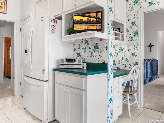 143 Cascade Caverns, Boerne, TX 78015 - kitchen with light tile patterned floors, white refrigerator with ice dispenser, white cabinetry, and wallpapered walls