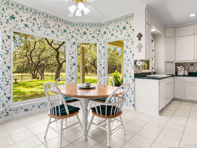 tiled dining area featuring plenty of natural light, crown molding, and ceiling fan