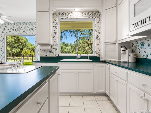 kitchen featuring white cabinets, light tile patterned floors, and ceiling fan