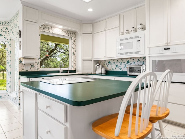 143 Cascade Caverns, Boerne, TX 78015 - kitchen featuring a sink, white appliances, white cabinets, and light tile patterned floors