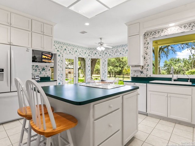 kitchen with ceiling fan, white cabinets, white appliances, sink, and light tile patterned floors