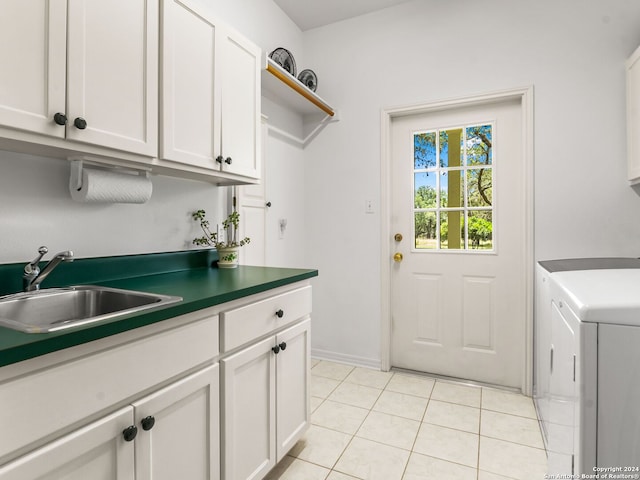 143 Cascade Caverns, Boerne, TX 78015 - laundry room featuring light tile patterned flooring, washing machine and clothes dryer, cabinet space, and a sink