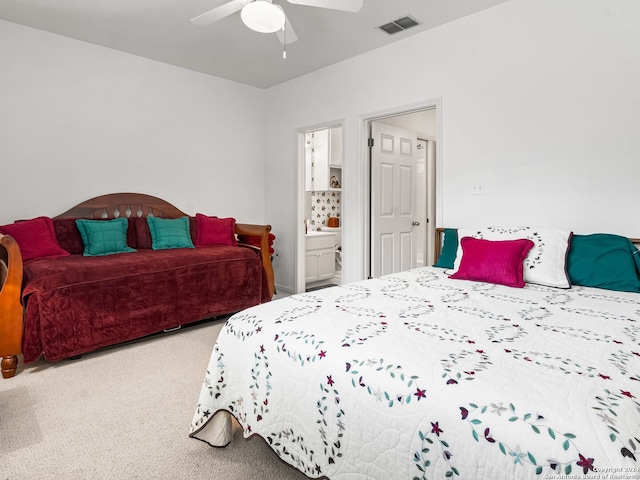 143 Cascade Caverns, Boerne, TX 78015 - carpeted bedroom with visible vents, ensuite bath, and ceiling fan