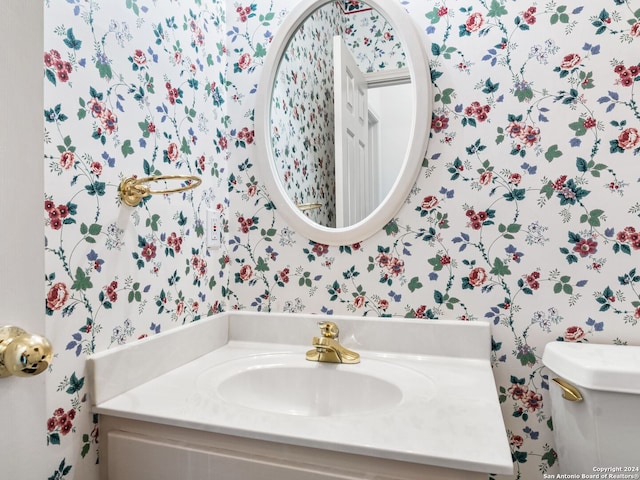 143 Cascade Caverns, Boerne, TX 78015 - bathroom featuring wallpapered walls, toilet, and vanity