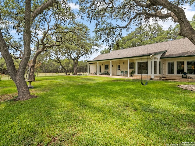 143 Cascade Caverns, Boerne, TX 78015 - rear view of property featuring a yard, a patio area, and a shingled roof