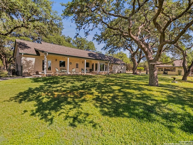 exterior space featuring a lawn and a patio area