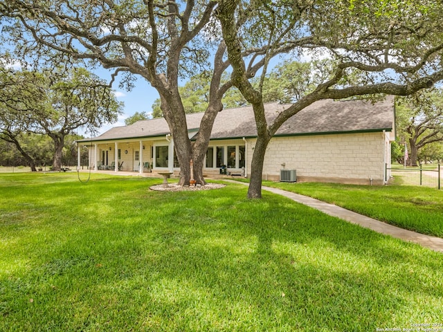 143 Cascade Caverns, Boerne, TX 78015 - back of property with central air condition unit, a patio, a lawn, and a shingled roof