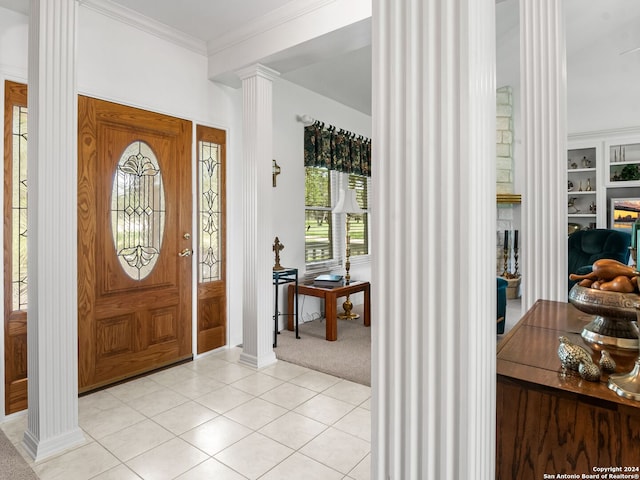 143 Cascade Caverns, Boerne, TX 78015 - foyer entrance featuring light tile patterned floors, baseboards, ornate columns, crown molding, and light colored carpet