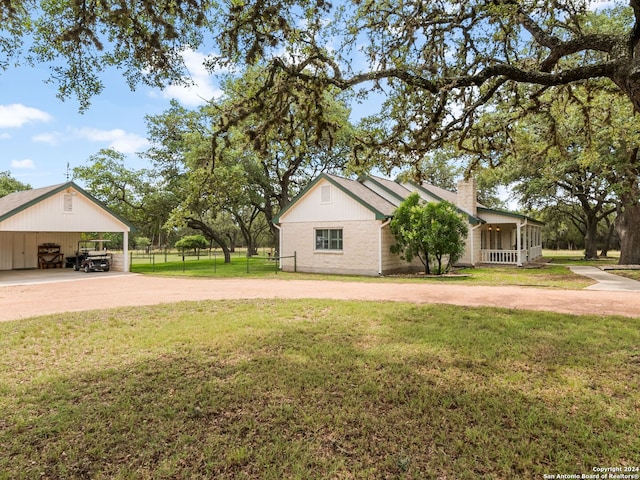 exterior space featuring a carport and a front lawn