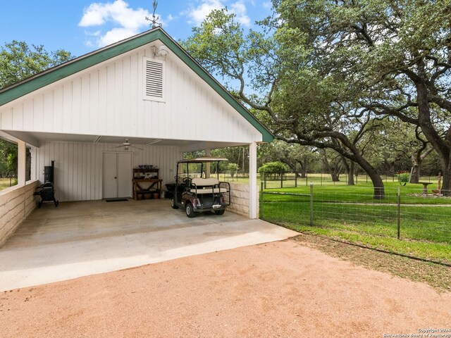 view of side of property with a lawn and a carport