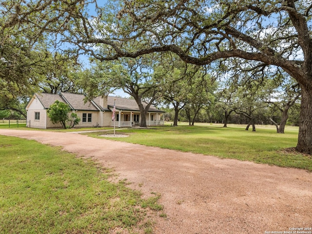 143 Cascade Caverns, Boerne, TX 78015 - ranch-style home with a front lawn and dirt driveway