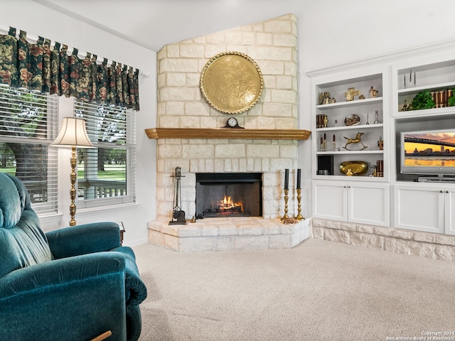 143 Cascade Caverns, Boerne, TX 78015 - carpeted living room featuring a stone fireplace and vaulted ceiling