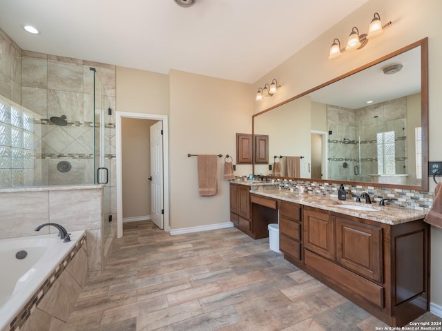 bathroom featuring plus walk in shower, hardwood / wood-style floors, and vanity