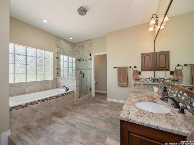 bathroom with vanity, wood-type flooring, and shower with separate bathtub