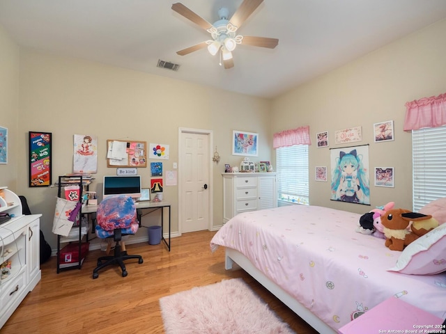 bedroom with light hardwood / wood-style floors and ceiling fan