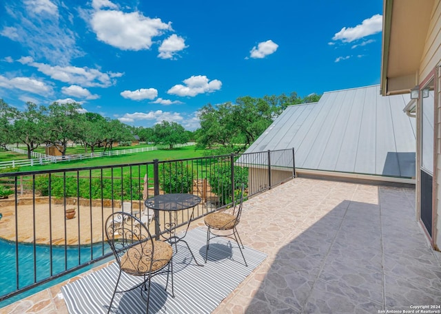 view of patio featuring a balcony