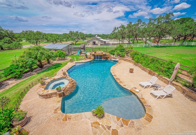 view of swimming pool featuring an in ground hot tub, a patio, and a lawn