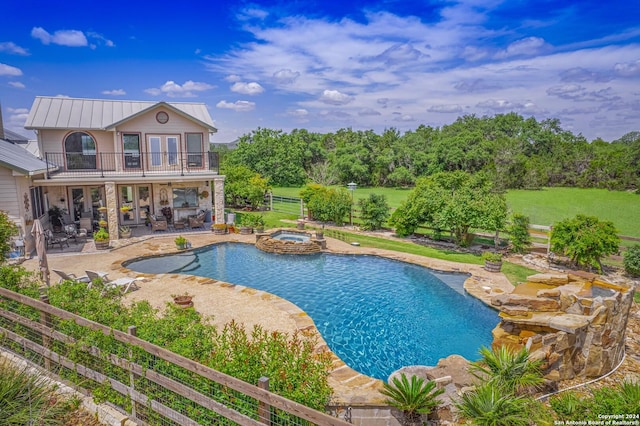 view of pool with an in ground hot tub and a patio area