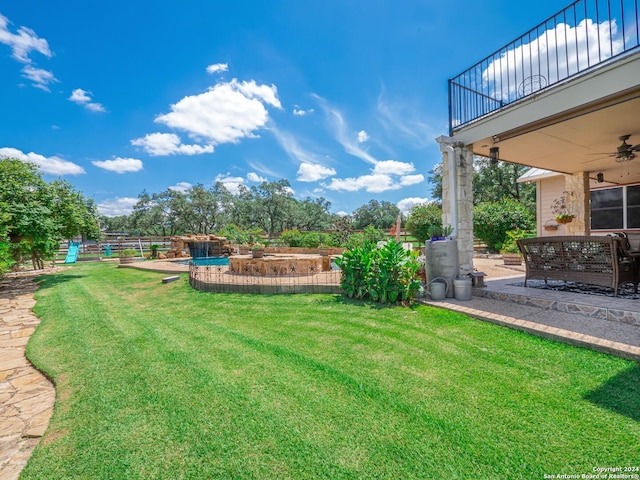 view of yard with a patio and ceiling fan