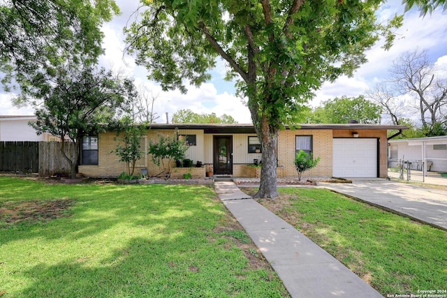 ranch-style home with a garage and a front lawn