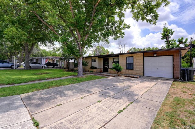 ranch-style house featuring a garage and a front lawn