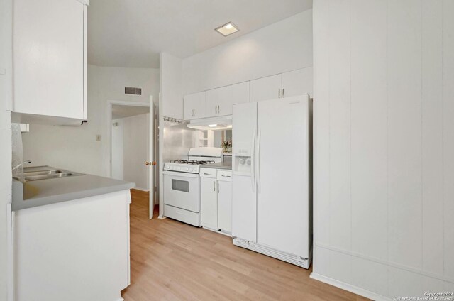 kitchen featuring sink, white appliances, white cabinets, and light wood-type flooring