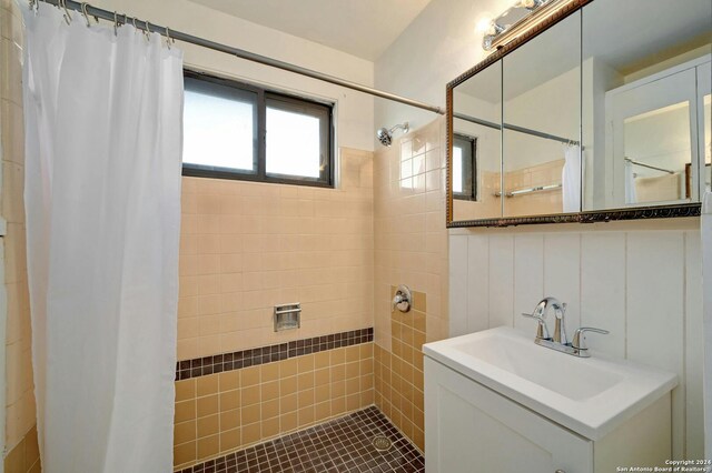 bathroom with sink and a shower with shower curtain