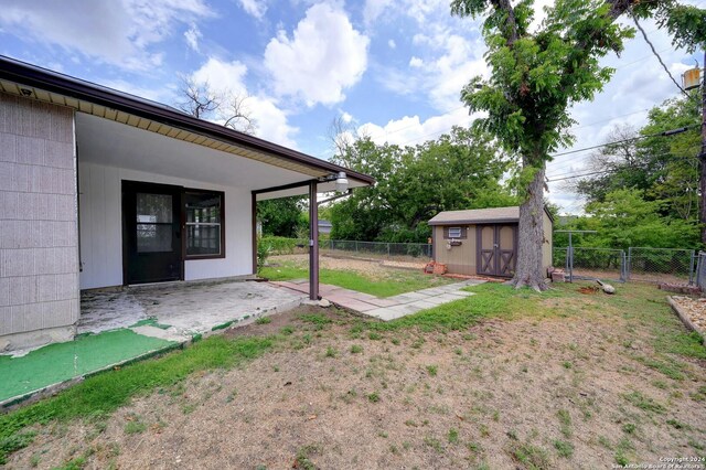 view of yard with a patio and a shed