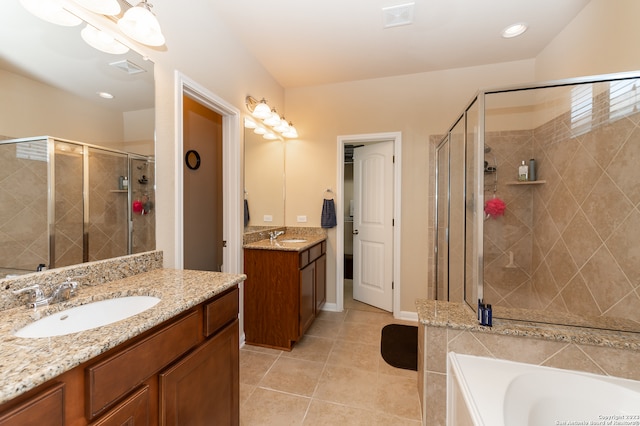 bathroom featuring tile patterned flooring, separate shower and tub, and dual vanity