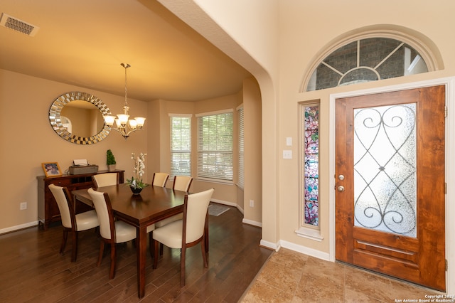 dining area with a notable chandelier and hardwood / wood-style floors