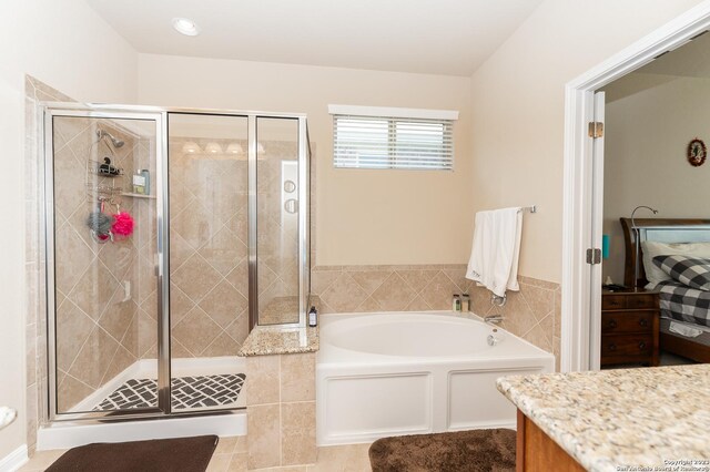 bathroom featuring vanity and separate shower and tub