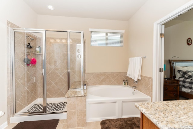 bathroom featuring shower with separate bathtub and vanity