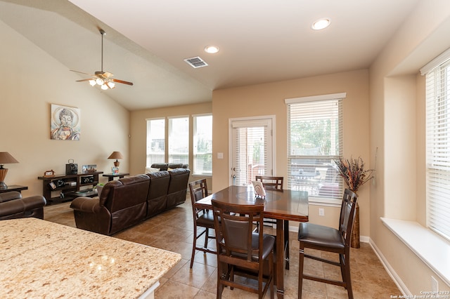 dining area featuring tile patterned flooring, ceiling fan, lofted ceiling, and a healthy amount of sunlight