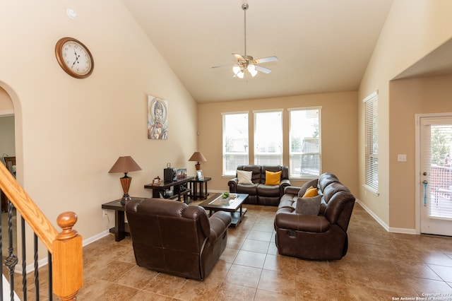 tiled living room with high vaulted ceiling and ceiling fan