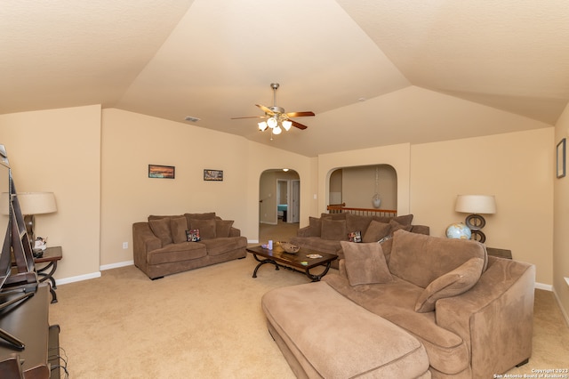 carpeted living room with ceiling fan and vaulted ceiling