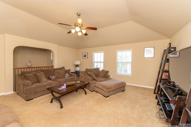 living room featuring light carpet, lofted ceiling, and ceiling fan