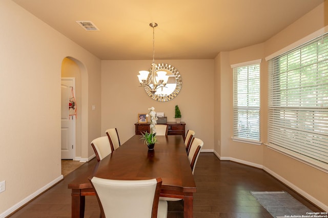 dining area featuring dark hardwood / wood-style floors and a notable chandelier