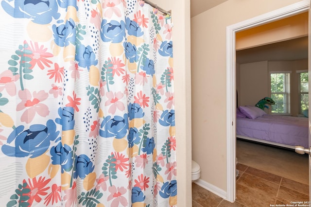 bathroom featuring toilet and tile patterned flooring