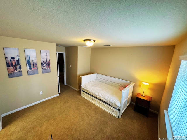 carpeted bedroom featuring a textured ceiling