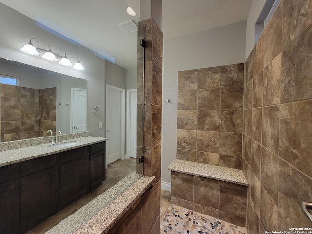 bathroom with walk in shower and vanity