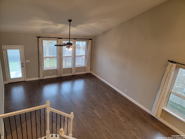 unfurnished dining area with ceiling fan and dark hardwood / wood-style floors