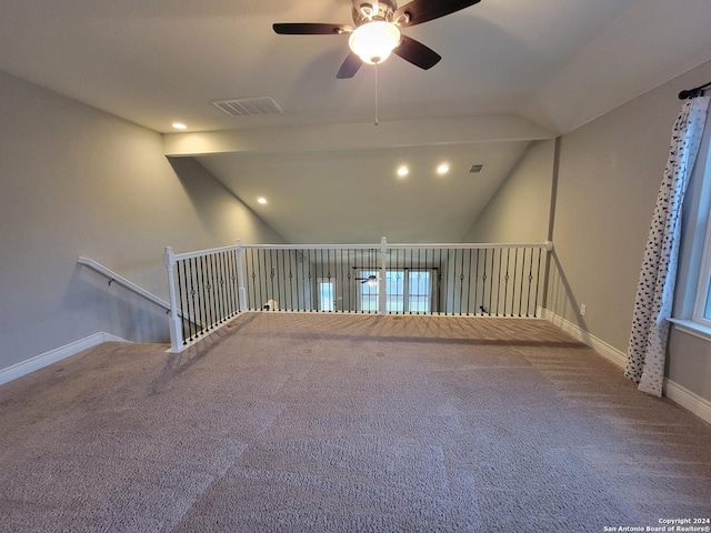 carpeted empty room featuring ceiling fan and lofted ceiling