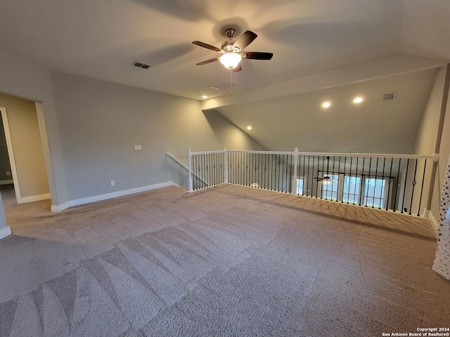 carpeted empty room with ceiling fan and lofted ceiling