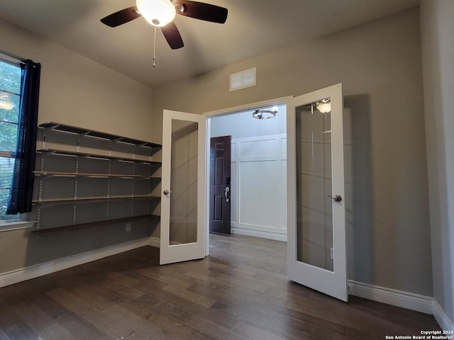 unfurnished bedroom with dark hardwood / wood-style floors, ceiling fan, and french doors